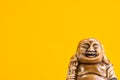 Ceramic Statue of Laughing Buddha on Bright Orange Background. Buddhism Religious Symbol. Minimalist Inspirational Image Royalty Free Stock Photo