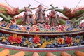Ceramic statue on rooftop of three Chinese traditional Gods and flower pattern Royalty Free Stock Photo