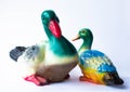 Ceramic statuette of a duck on a white background with brightly colored feathers. Duckling with mother duck Royalty Free Stock Photo