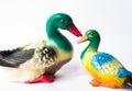 Ceramic statuette of a duck on a white background with brightly colored feathers. Duckling with mother duck Royalty Free Stock Photo