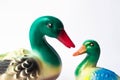 Ceramic statuette of a duck on a white background with brightly colored feathers. Duckling with mother duck Royalty Free Stock Photo