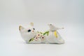 Porcelain figurine, Ceramic cat, bird, gold accents, glossy finish, crafted, traditional attire, folk hand-painted