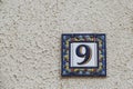 Ceramic street plaque decorated with number nine Royalty Free Stock Photo