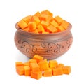 Ceramic tan pan filled with chopped pumpkin slices isolated on a white Royalty Free Stock Photo