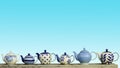 Ceramic Teapot With Blue Pastel Wall Background.