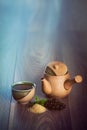 Ceramic teapot, cup of black tea with mint leaves and brown sugar on wooden table with copy space. Royalty Free Stock Photo