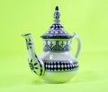 Ceramic teapot isolated on green background morocco