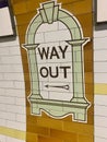 Ceramic tiles point the way to the exit of a London Tube station