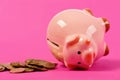 Ceramic toy pig on back with money fallen out Royalty Free Stock Photo