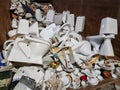 Ceramic trash in a recycling container. Broken toilet seats, kitchen ceramic ware, broken cups and plates