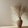 A ceramic vase with a smooth, earthy texture holds an arrangement of thin, bare Royalty Free Stock Photo