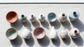 Ceramic vases and bowls are arranged on a light fabric surface. The Royalty Free Stock Photo
