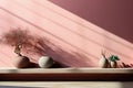 Ceramic vases on a white bench, a sunny shadow on the pink wall
