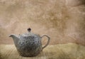 A ceramic vintage teapot on bamboo mat