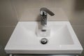 Ceramic washbasin with hot and cold faucet in luxury hotel bathroom Royalty Free Stock Photo