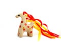 Ceramic whistle horse with a mane of yellow and red ribbons and painted with flowers isolated on a white background Royalty Free Stock Photo