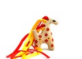 Ceramic whistle horse with a mane of yellow and red ribbons and painted with flowers isolated on a white background Royalty Free Stock Photo