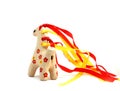 Ceramic whistle horse with a mane of yellow and red ribbons and painted with flowers isolated on a white background Royalty Free Stock Photo
