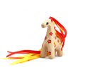 Ceramic whistle horse with a mane of yellow and red ribbons and painted with flowers  on a white background Royalty Free Stock Photo