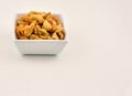 Ceramic white bowl filled with salty cashew nuts Royalty Free Stock Photo