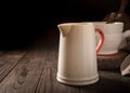 Ceramic white jug with red handle Royalty Free Stock Photo