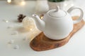Ceramic white teapot with accessories on a white table, horizontal frame, tea time, tea drinking, retual tea making Royalty Free Stock Photo