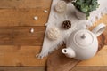 Ceramic white teapot with accessories on a wooden table, horizontal frame, tea time, tea drinking, retual tea making