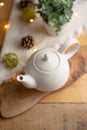 Ceramic white teapot with accessories on a wooden table, vertical frame, tea time, tea drinking, retual tea making Royalty Free Stock Photo