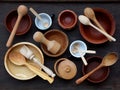 Ceramic, wooden, clay empty handmade bowl, cup and spoon on dark background. Pottery earthenware utensil, kitchenware. Royalty Free Stock Photo