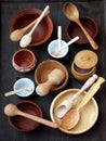 Ceramic, wooden, clay empty handmade bowl, cup and spoon on dark background. Pottery earthenware utensil, kitchenware. Royalty Free Stock Photo