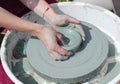 Ceramic workshop - the girl makes a pot of clay on a potter`s wheel. Hands closeup Royalty Free Stock Photo