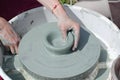 Ceramic workshop - the girl makes a pot of clay on a potter`s wheel. Hands closeup Royalty Free Stock Photo