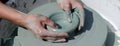 Ceramic workshop - the girl makes a pot of clay on a potter`s wheel. Hands closeup. Horizontal photo Royalty Free Stock Photo