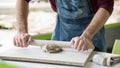 Ceramist Dressed in an Apron Working with Raw Clay in Bright Ceramic Workshop. Royalty Free Stock Photo