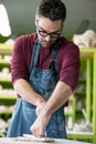 Ceramist Dressed in an Apron Working with Raw Clay in Bright Ceramic Workshop. Royalty Free Stock Photo