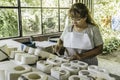 Woman ceramist working in ceramic studio.