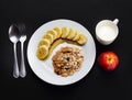 Cereal with banana topped with honey, milk and apple to health