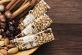 Cereal bars with nuts, berries and cinnamon on a wooden background. Top view, copy space. Food background Royalty Free Stock Photo