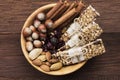 Cereal bars with nuts, berries and cinnamon on a wooden background. Top view. Food background Royalty Free Stock Photo