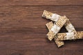 Cereal bars with nuts, berries and cinnamon on a wooden background. Top view, copy space. Food background Royalty Free Stock Photo