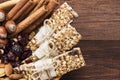 Cereal bars with nuts, berries and cinnamon on a wooden background. Top view, copy space. Food background Royalty Free Stock Photo