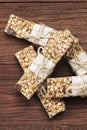 Cereal bars with nuts, berries and cinnamon on a wooden background. Top view, copy space. Food background Royalty Free Stock Photo