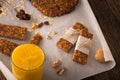 Cereal bars with raisins, nuts and orange juice.