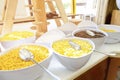 Cereal in big bowls for self service dry quick breakfast food in hotel restaurant selection on white table against window. buffet Royalty Free Stock Photo