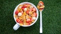 Cereal bowl and spoon on grass background