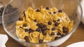 Glass bowl of Cornflakes with chocolate balls and milk on a wooden table. Cereal breakfast. Healthy quick food concept Royalty Free Stock Photo