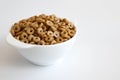 Cereal cheerios in bowl on white background Royalty Free Stock Photo