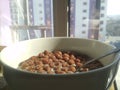 Cereal chocolate balls in bowl with milk on rustic wooden table Royalty Free Stock Photo