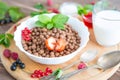 Cereal chocolate balls in bowl with milk on rustic wooden table Healthy tasty breakfast chocolate balls with Royalty Free Stock Photo