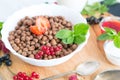 Cereal chocolate balls in bowl with milk on rustic wooden table Healthy tasty breakfast chocolate balls with Royalty Free Stock Photo